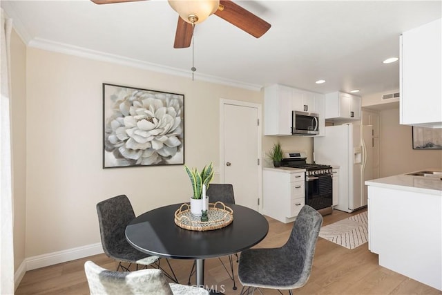 dining room featuring recessed lighting, visible vents, ornamental molding, light wood-type flooring, and baseboards