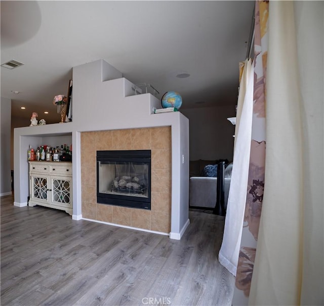 unfurnished living room with a fireplace and wood-type flooring