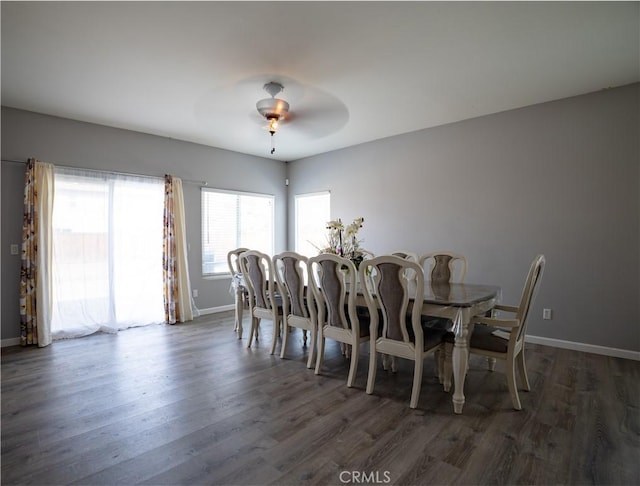 dining room with dark hardwood / wood-style flooring and ceiling fan