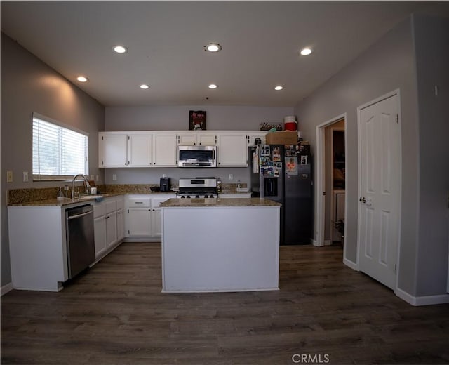 kitchen with white cabinetry, dark wood-type flooring, appliances with stainless steel finishes, and a center island