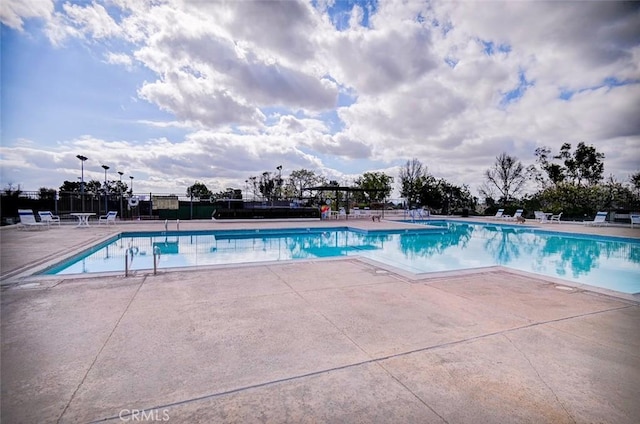 view of swimming pool featuring a pergola and a patio