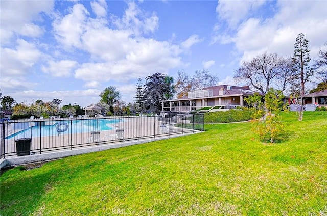 view of swimming pool with a lawn