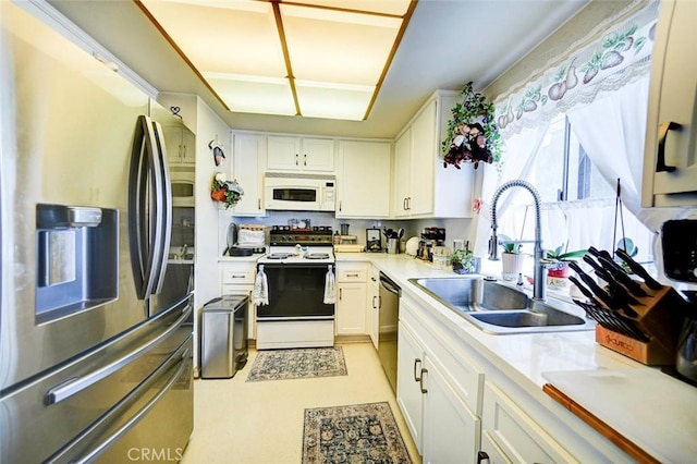 kitchen featuring stainless steel appliances, sink, and white cabinets