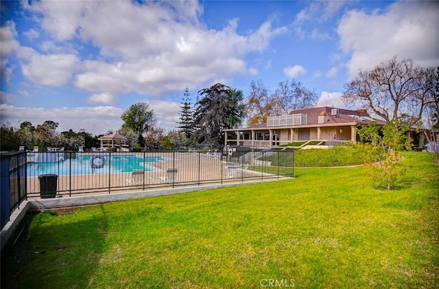 view of swimming pool featuring a patio area and a lawn