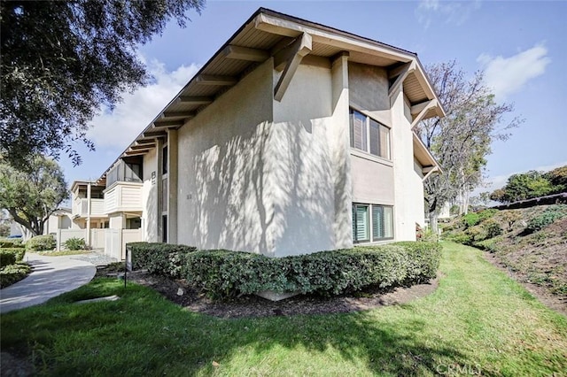 view of side of property with a lawn