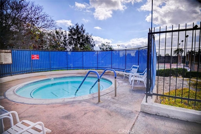 view of swimming pool featuring a community hot tub