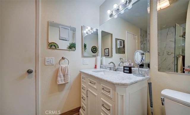 bathroom with vanity, toilet, and an enclosed shower