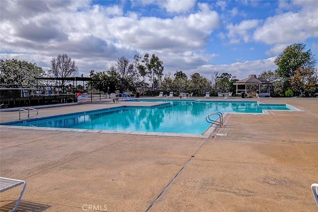 view of swimming pool with a gazebo and a patio area