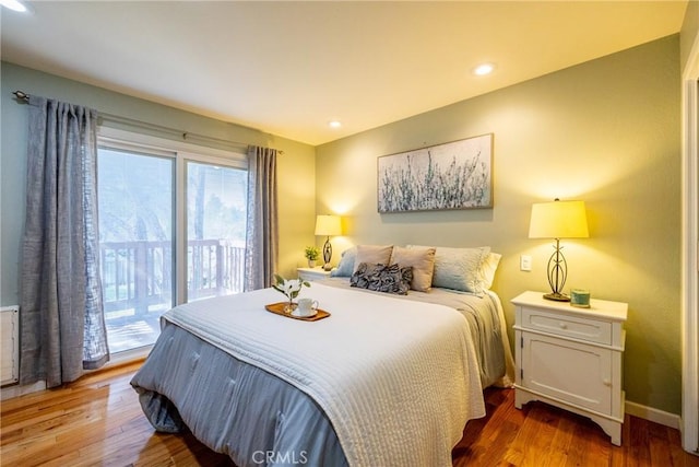 bedroom featuring hardwood / wood-style floors and access to outside