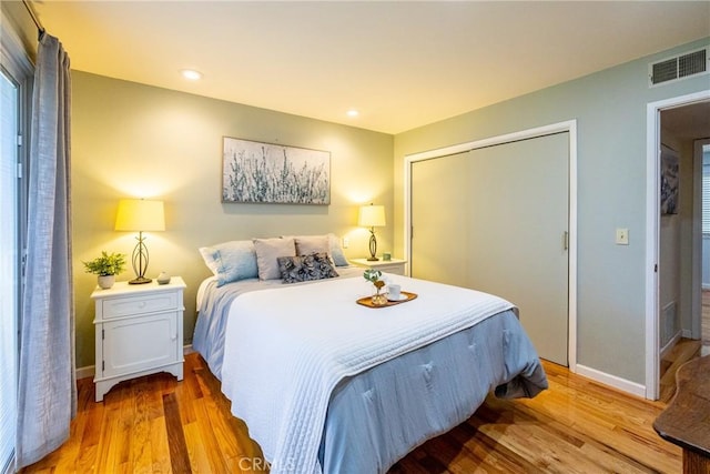 bedroom featuring hardwood / wood-style floors and a closet