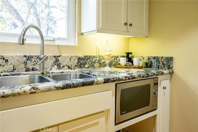 kitchen with sink and stone counters