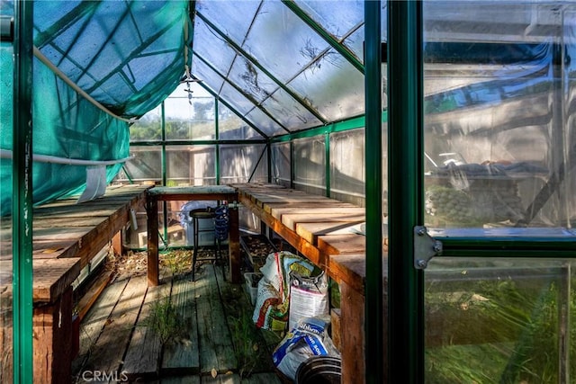 sunroom / solarium featuring lofted ceiling