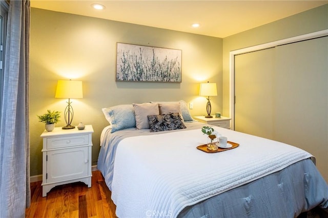 bedroom featuring a closet and dark hardwood / wood-style floors