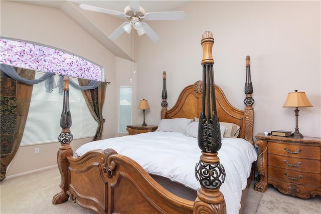 bedroom featuring vaulted ceiling, light colored carpet, and ceiling fan