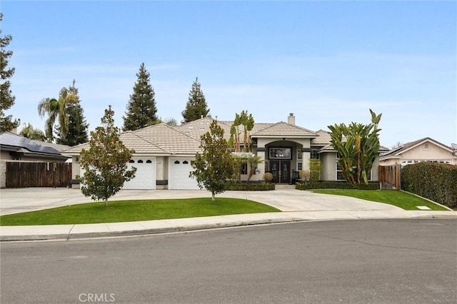 view of front facade featuring a garage and a front lawn