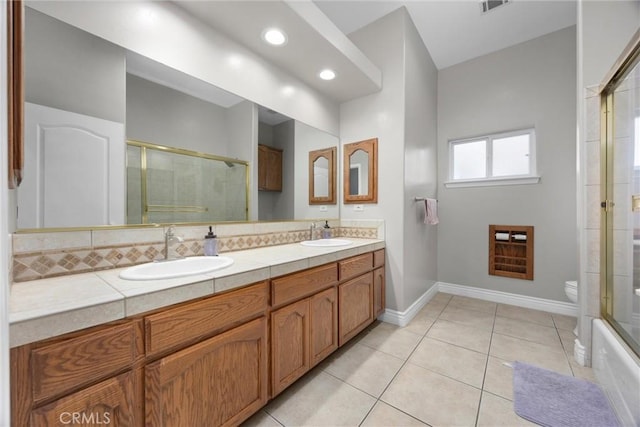 full bathroom featuring vanity, tile patterned floors, shower / bath combination with glass door, and toilet