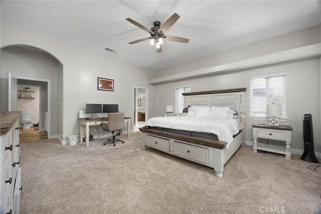 carpeted bedroom featuring ceiling fan and ensuite bathroom