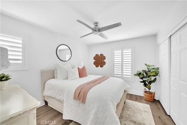 bedroom with a closet, ceiling fan, and light hardwood / wood-style flooring