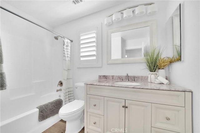 full bathroom featuring shower / tub combo with curtain, toilet, and vanity