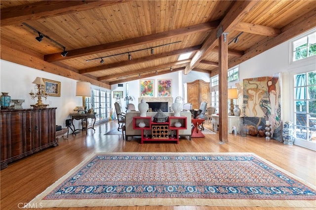 living room featuring wood ceiling, vaulted ceiling with beams, hardwood / wood-style flooring, and a wealth of natural light