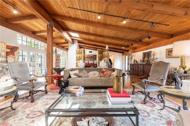 living room with lofted ceiling with beams, wood ceiling, and light hardwood / wood-style flooring