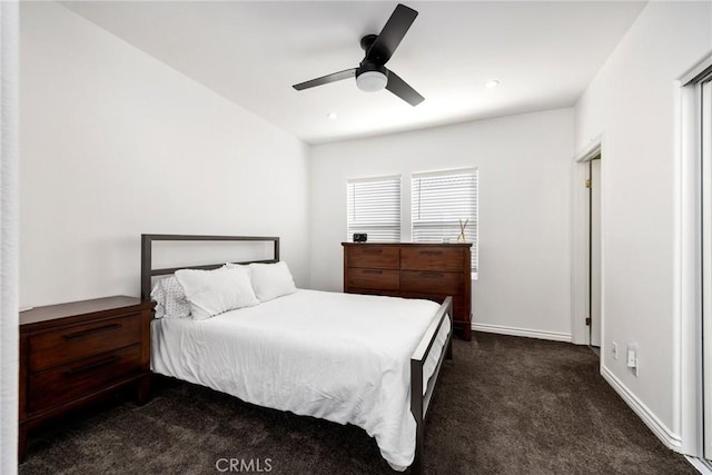 bedroom featuring ceiling fan and dark colored carpet