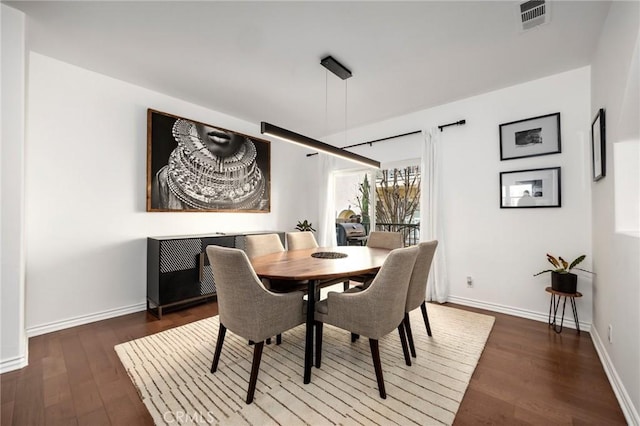 dining space with dark wood-type flooring