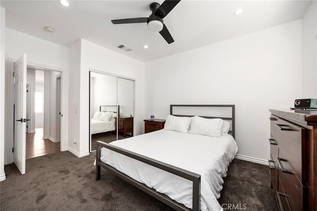 carpeted bedroom with ceiling fan and a closet