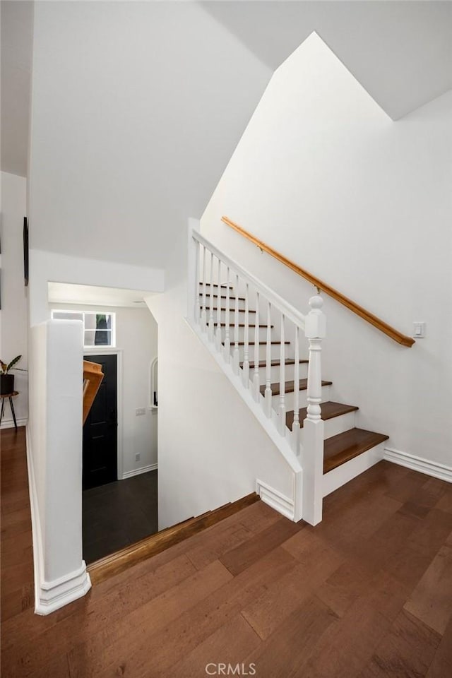 staircase with wood-type flooring