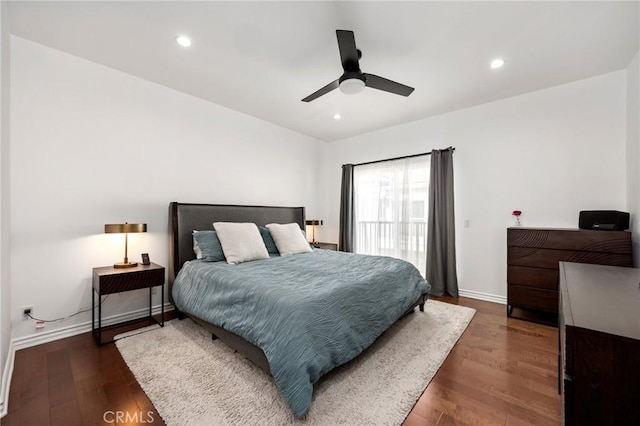 bedroom with dark hardwood / wood-style flooring, access to outside, and ceiling fan