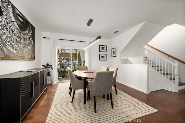 dining area with dark hardwood / wood-style floors