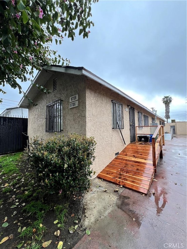 exterior space with fence and stucco siding