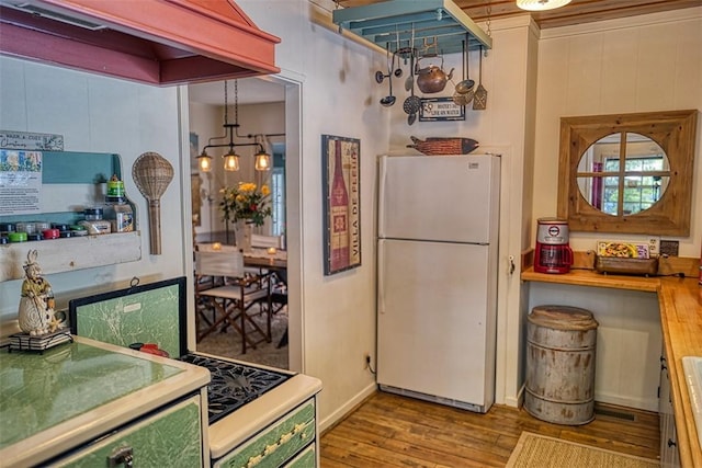 kitchen with light hardwood / wood-style flooring and white refrigerator