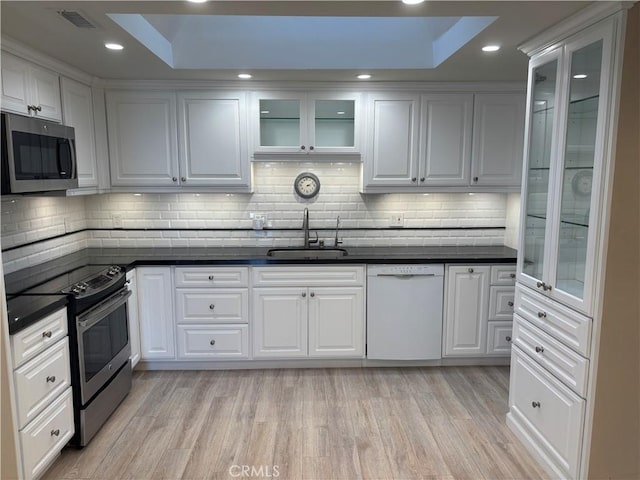 kitchen with white cabinetry, sink, and stainless steel appliances