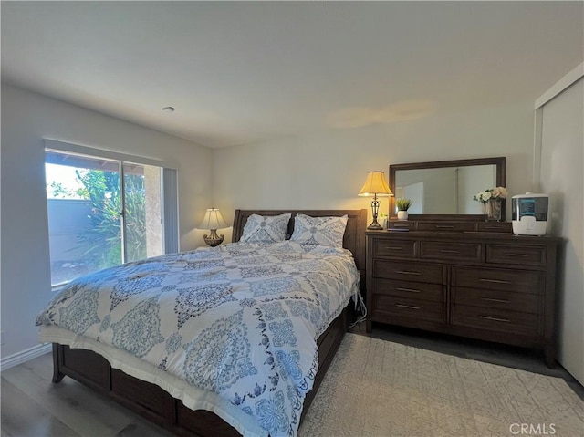 bedroom with hardwood / wood-style flooring