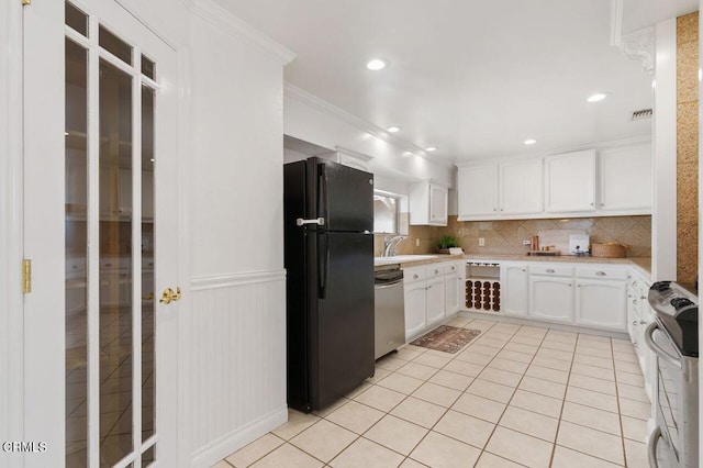 kitchen with crown molding, light tile patterned floors, stainless steel appliances, light countertops, and backsplash