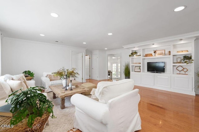 living room with light wood finished floors, crown molding, and recessed lighting