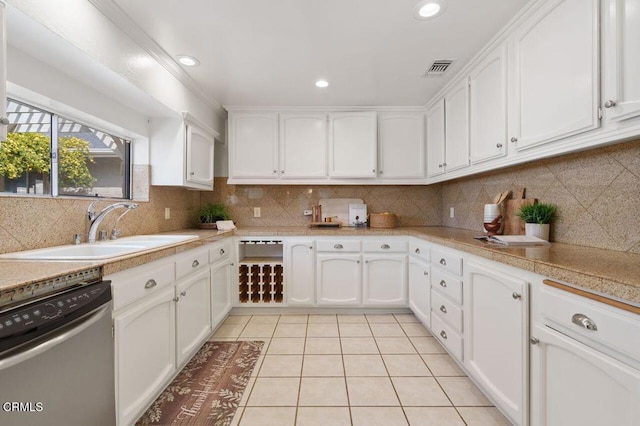 kitchen with a sink, light tile patterned floors, white cabinets, and dishwasher