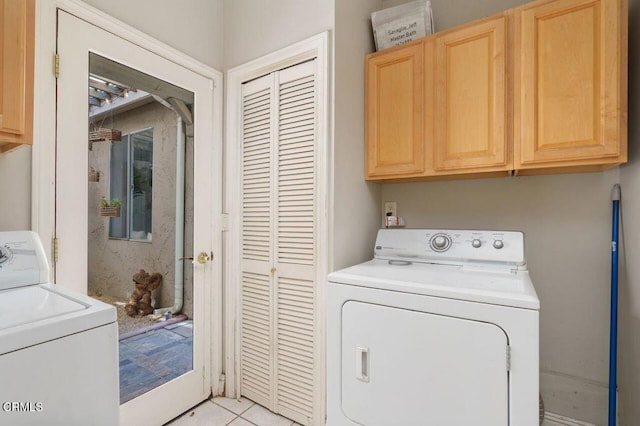 clothes washing area featuring washer and dryer and cabinet space