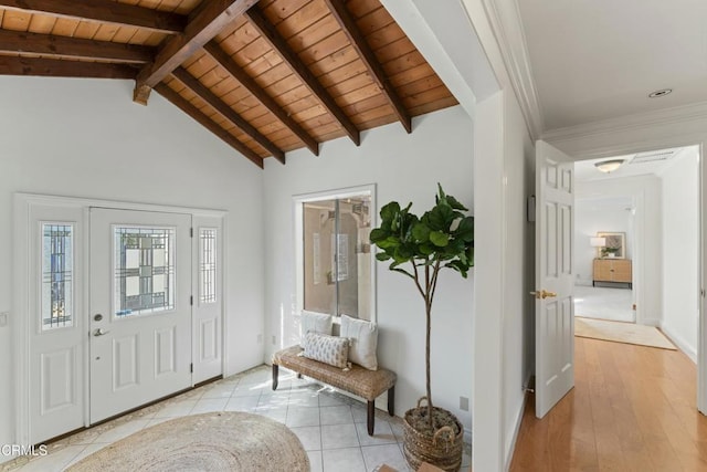 foyer featuring wooden ceiling, vaulted ceiling with beams, and light tile patterned floors