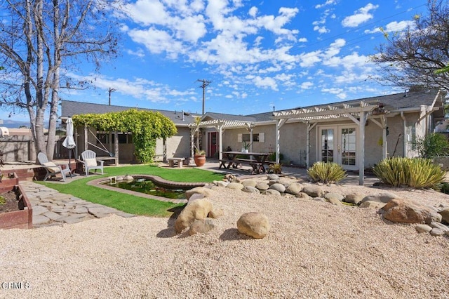 back of property featuring french doors, stucco siding, a patio area, fence, and a pergola