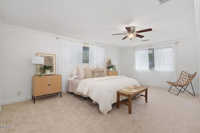 bedroom with visible vents, ornamental molding, a ceiling fan, light carpet, and baseboards