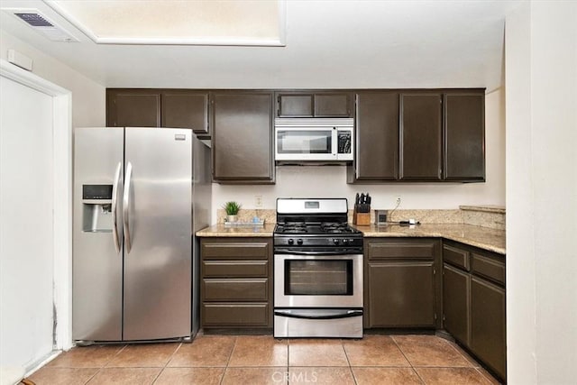8556 Baldy Vista Dr, Rancho Cucamonga, CA 91730 - kitchen with dark brown cabinetry, visible vents, light tile patterned flooring, and appliances with stainless steel finishes