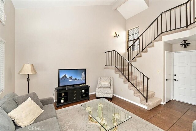 8556 Baldy Vista Dr, Rancho Cucamonga, CA 91730 - tiled living room featuring high vaulted ceiling, stairway, baseboards, and beam ceiling