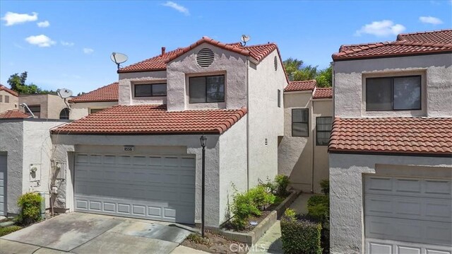 8556 Baldy Vista Dr, Rancho Cucamonga, CA 91730 - mediterranean / spanish-style house with a tiled roof, driveway, stucco siding, and a garage