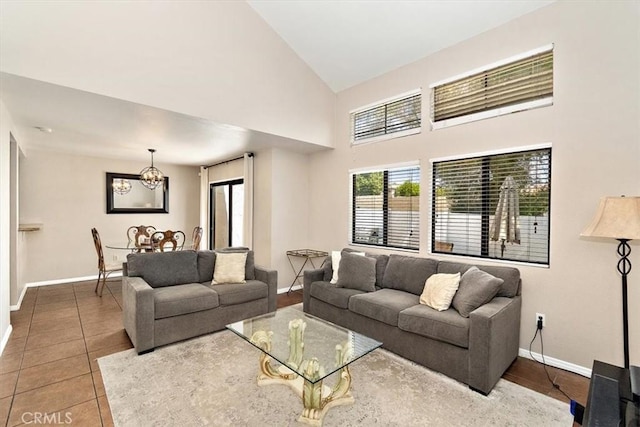 8556 Baldy Vista Dr, Rancho Cucamonga, CA 91730 - living room featuring tile patterned floors, high vaulted ceiling, an inviting chandelier, and baseboards