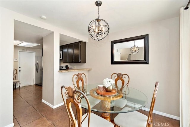 8556 Baldy Vista Dr, Rancho Cucamonga, CA 91730 - tiled dining space featuring a notable chandelier and baseboards