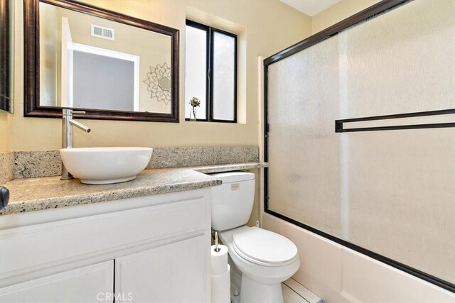 8556 Baldy Vista Dr, Rancho Cucamonga, CA 91730 - bathroom featuring toilet, enclosed tub / shower combo, vanity, and visible vents
