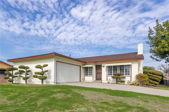 view of front of home with a garage and a front yard