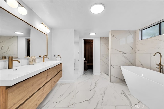 bathroom with vanity, a textured ceiling, and a bathing tub